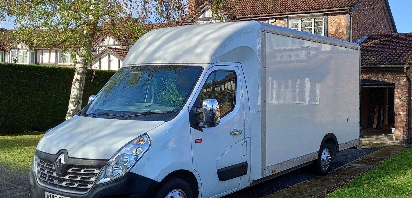 The clean white Move Removals van is proudly parked outside a neat property ready for work